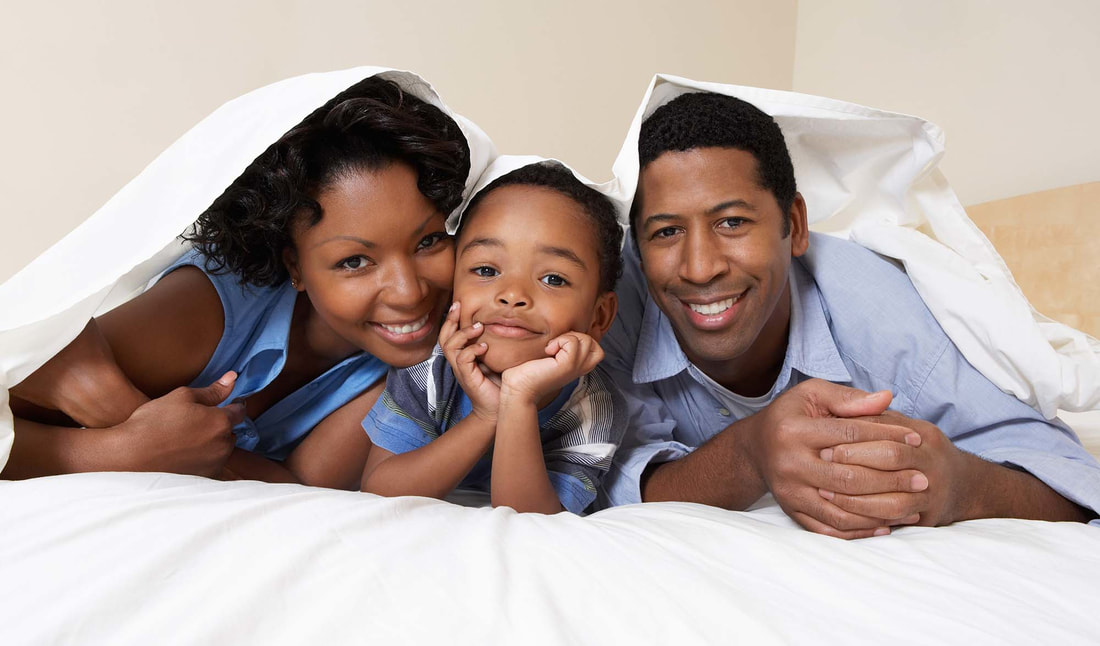 Young african american family of three playing in their bedroom - Free Insurance Quotes - Contact Us now